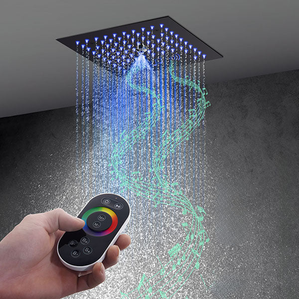 Hand reaching for the remote while Cascada Royale LED shower runs — 64 colors from across the room