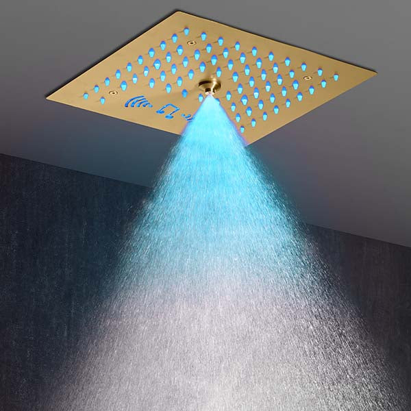 Warm amber light fills the shower as water falls from the Cascada Royale recessed ceiling head