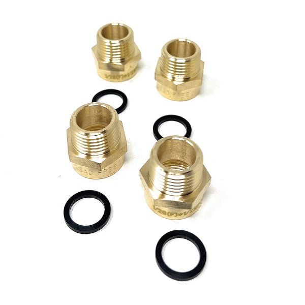 Set of brass plumbing fittings and washers on a white background