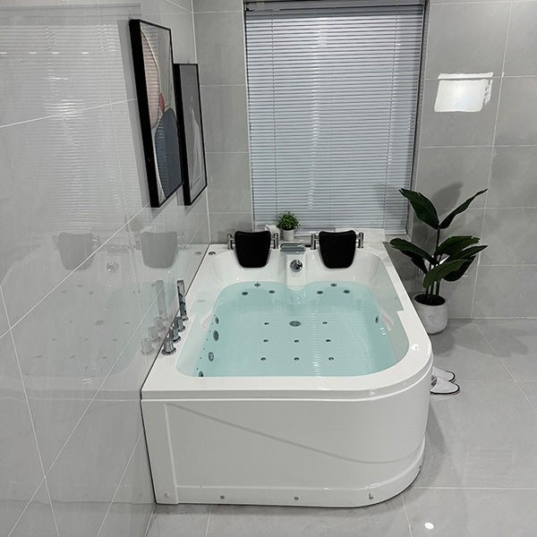 Modern bathroom with a Jacuzzi bathtub, tiled walls, and a window.