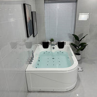 Modern bathroom with a Jacuzzi bathtub, tiled walls, and a window.