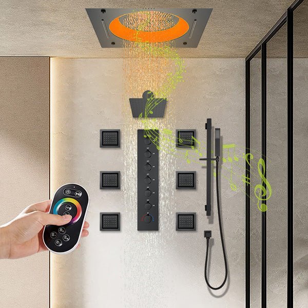 Shower system with rain shower head, handheld shower, and remote control in a modern bathroom setting.